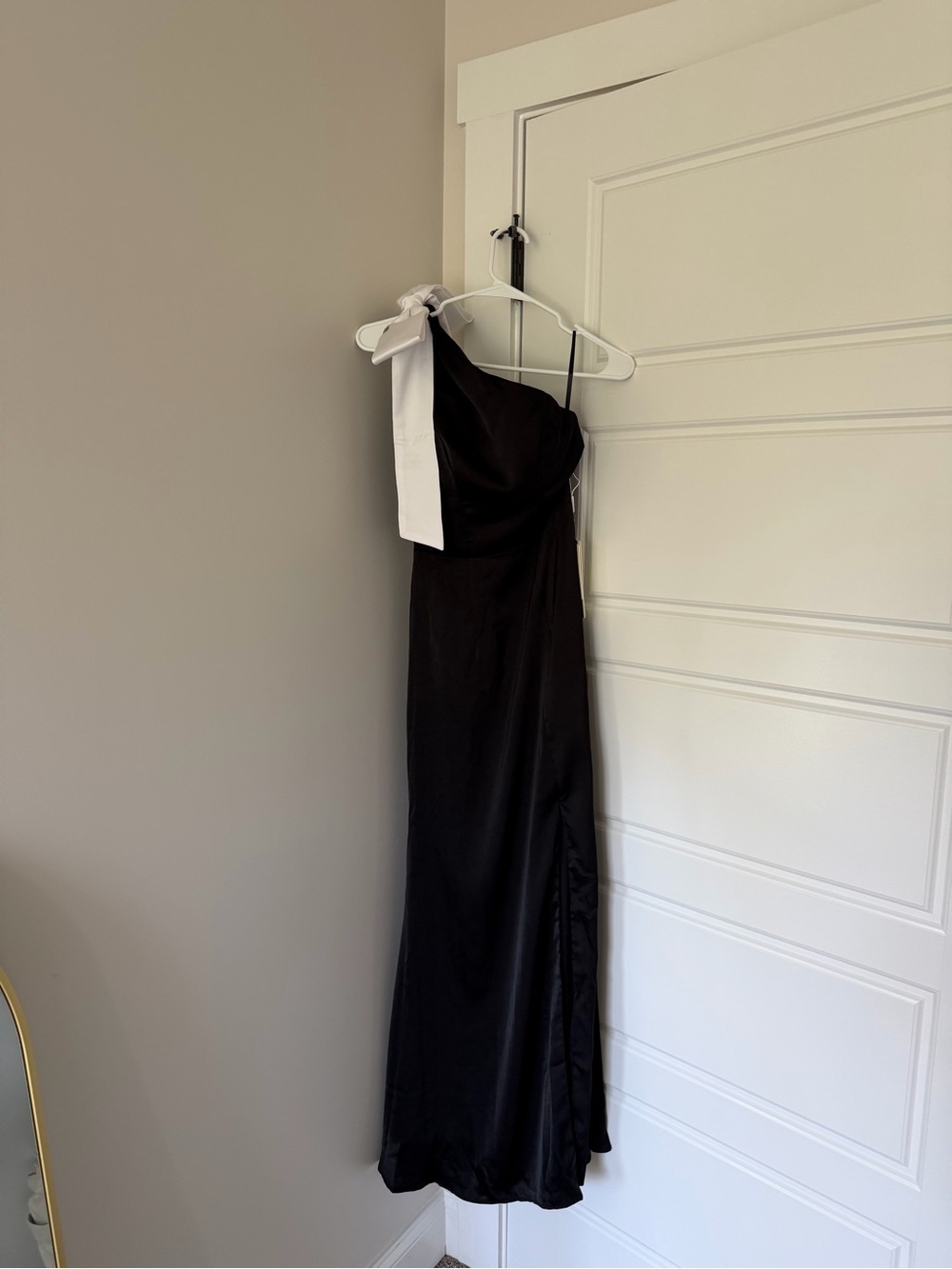 One-Shoulder Black Satin Gown with White Bow Accent